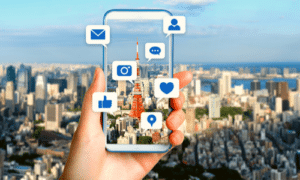 cityscape background with a hand holding a cell phone that has apps jumping out from the screen