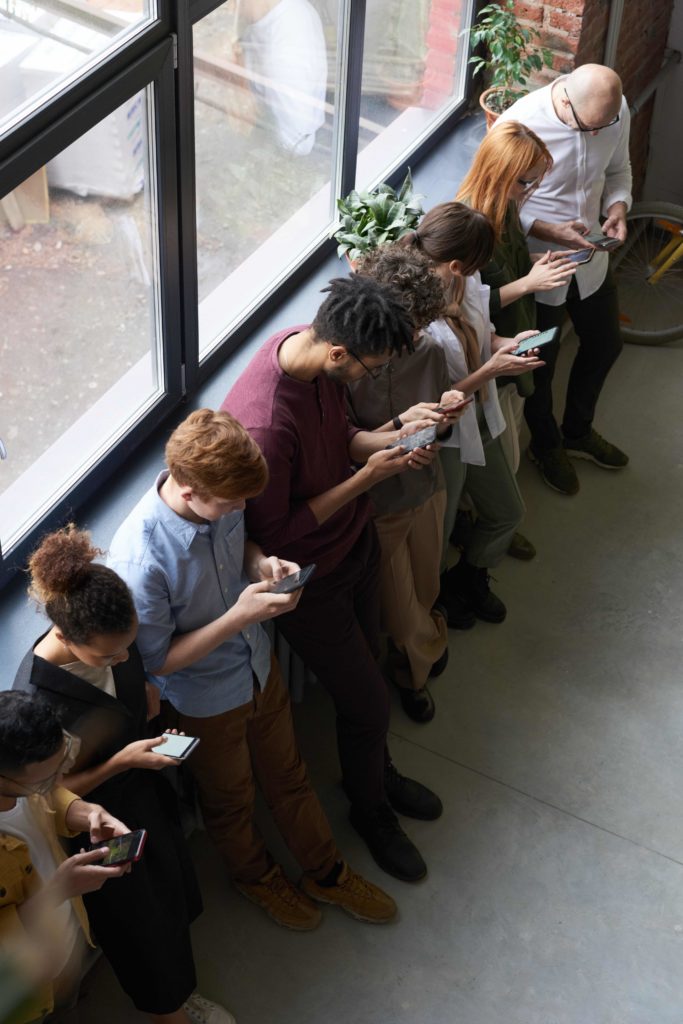 teenagers looking at phones
