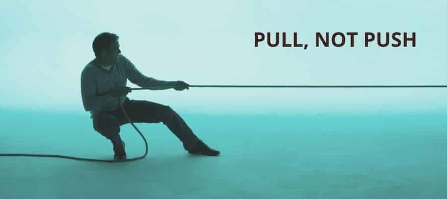 Pull, not push - Man playing tug of war on a blue background