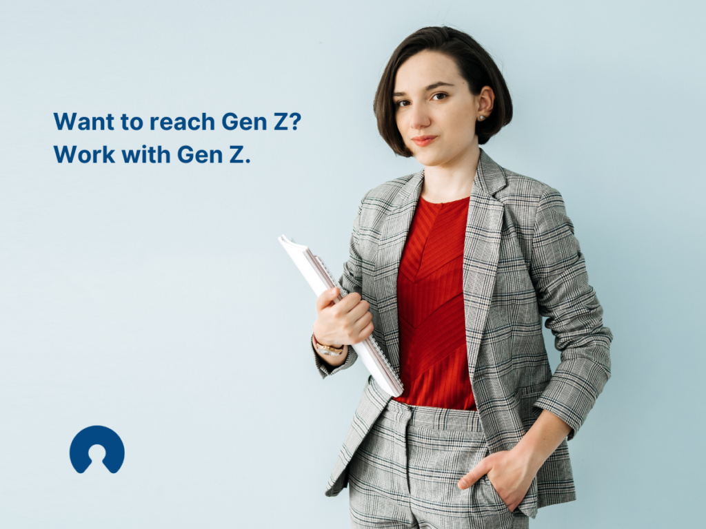 Gen Z business woman holding a stack of papers.